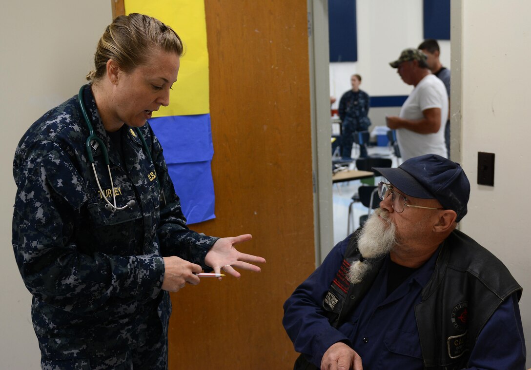 Navy Lt. Jennifer Turney, a physician’s assistant from the Expeditionary Medical Force of Camp Pendleton, Calif., concludes an initial health assessment with patient Robert Olsen during Innovative Readiness Training at Mountain Home, Ark., June 12, 2017. The IRT program allows active-duty, guard and reserve members to volunteer for real-world training opportunities through engineering, veterinarian, medical, and construction projects that benefit the sometimes-forgotten citizens of American communities in need. (U.S. Air National Guard photo by Staff Sgt. Carlynne DeVine)