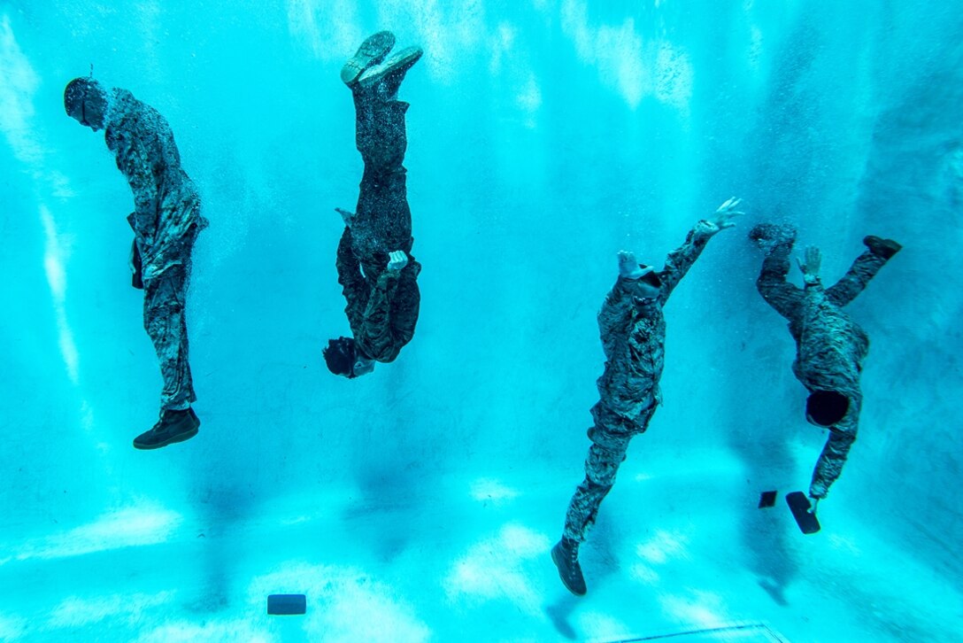 U.S. Marines with the 1st Marine Logistics Group (MLG) participate in the water survival advanced course at Camp Pendleton, California, June 14, 2017. The purpose of the water survival course is to strengthen the individual Marine’s self-preservation and rescue skills in water. 1st MLG is home to multiple military occupations that work together to provide support to each element of the 1st Marine Expeditionary Force through logistics beyond the capabilities of the supported units. (U.S. Marine Corps photo by Sgt. Rodion Zabolotiny)