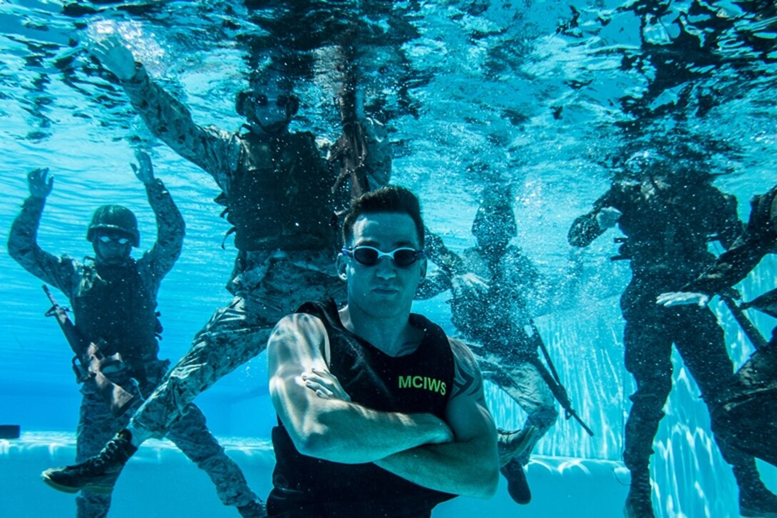 U.S. Marine Cpl. Daniel Ramech, a Marine Corps Instructor of Water Survival with Headquarters Regiment, 1st Marine Logistics Group, observes a water survival advanced course on Camp Pendleton, Calif., June 14, 2017. MCIWS teaches Marines how to improve their abilities in surviving and saving others in water. 1st MLG is home to multiple military occupations that work together to provide support to each element of the 1st Marine Expeditionary Force through logistics beyond the capabilities of the supported units. (U.S. Marine Corps photo by Sgt. Rodion Zabolotiny)
