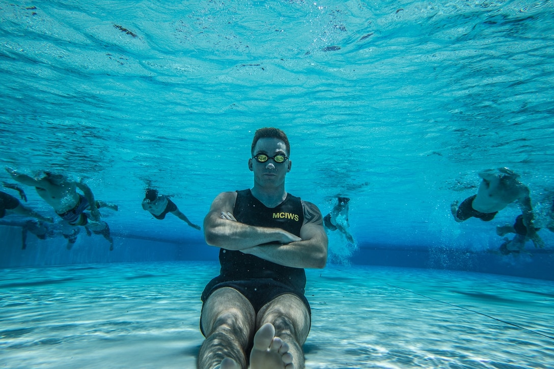 U.S. Marine Cpl. Daniel Ramech, a Marine Corps Instructor of Water Survival with Headquarters Regiment, 1st Marine Logistics Group, observes a water survival advanced course on Camp Pendleton, Calif., June 12, 2017. MCIWS teaches Marines how to improve their abilities in surviving and saving others in water. 1st MLG is home to multiple military occupations that work together to provide support to each element of the 1st Marine Expeditionary Force through logistics beyond the capabilities of the supported units. (U.S. Marine Corps photo by Lance Cpl. Adam Dublinske)