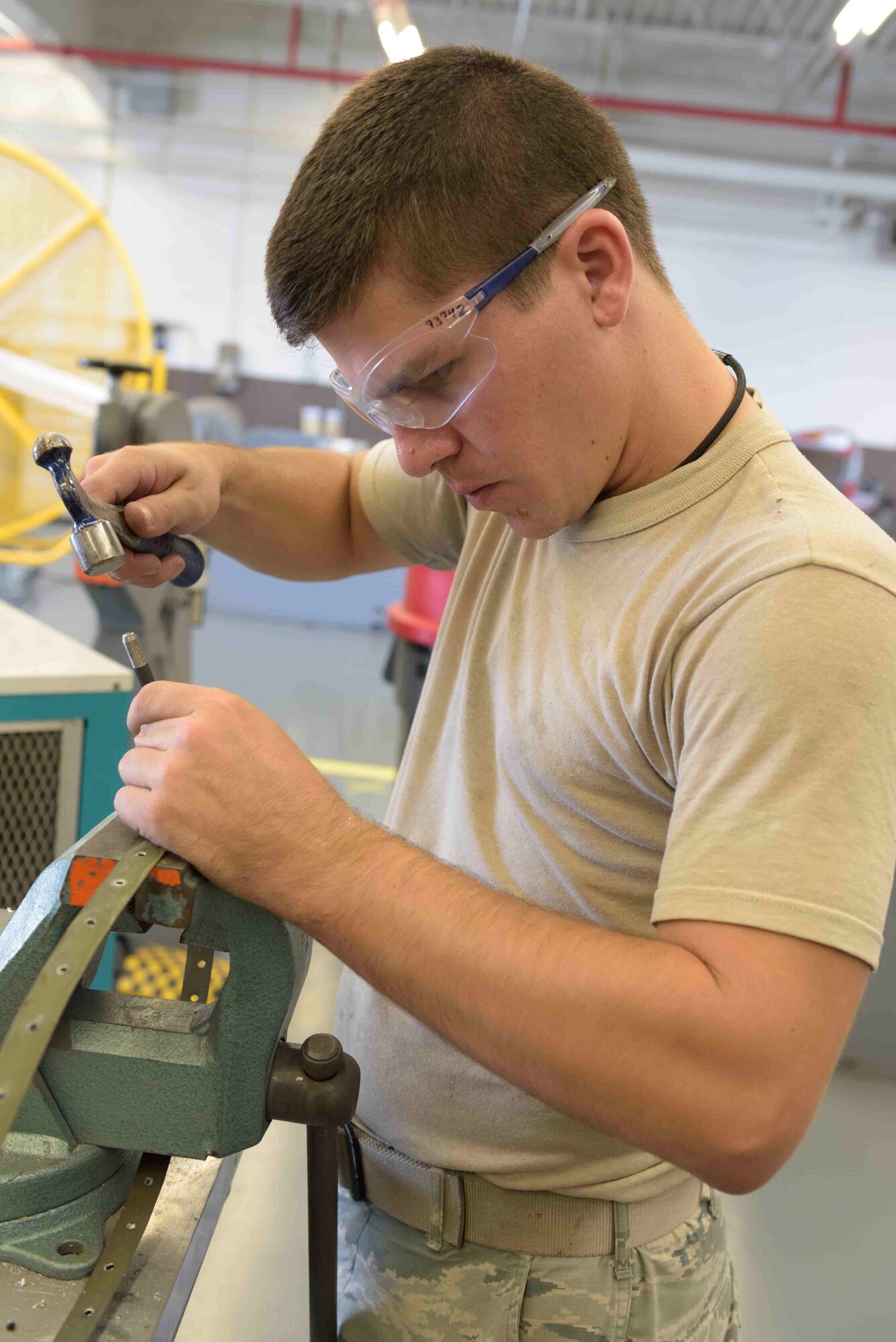 Senior Airman Cayce Bennett, 403rd Fabrication Flight aircraft structural maintenance technician, hammers out all rivet tails from part of the pylon of a C-130J Super Hercules aircraft at Keesler Air Force Base, Mississippi, June 13, 2017. This was part of a regular maintenance project to replace the seals of the pylons to help prevent water and other fluids from leaking in to the aircraft and causing corrosion. (U.S. Air Force photo/Tech. Sgt. Ryan Labadens)