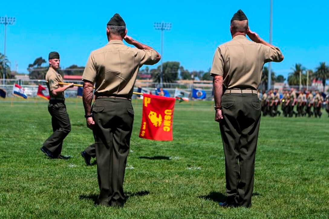 U.S. Marine Cols. Phillip N. Frietze (left) and James R. Hensien (right) return a salute during the pass in review at the 1st Marine Logistics Group Headquarters Regiment Change of Command on Camp Pendleton, Calif., June 15, 2017. The ceremony included marching of the colors, passing of the regimental colors, presenting Frietze his award and closing remarks from the oncoming and off going personnel as well as the 1st MLG Commanding General, Brig. Gen. David A. Ottignon. (U.S. Marine Corps photo by Lance Cpl. Joseph Sorci)