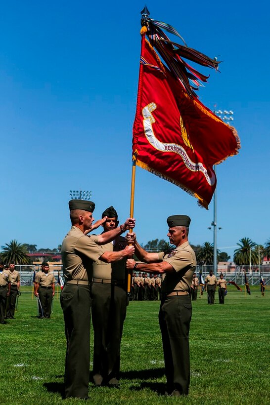 U.S. Marine Cols. Phillip N. Frietze (left) and James R. Hensien (right) exchange the regimental colors at the 1st Marine Logistics Group Headquarters Regiment Change of Command on Camp Pendleton, Calif., June 15, 2017. The ceremony included marching of the colors, passing of the regimental colors, presenting Frietze his award and closing remarks from the oncoming and off going personnel as well as the 1st MLG Commanding General, Brig. Gen. David A. Ottignon. (U.S. Marine Corps photo by Lance Cpl. Joseph Sorci)