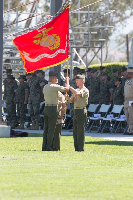 U.S. Marine Col. James R. Hensein returns the regimental colors to Sgt. Maj. Carlos A. Ruiz during the Headquarters Regiment, 1st Marine Logistics Group, change of command ceremony on Camp Pendleton, Calif., June 15, 2017. The ceremony included marching of the colors, passing of the regimental colors, presenting Col. Frietze his away and closing remarks from the oncoming and off going personnel as well as the 1st Marine Logistics Group Commanding General, Brig. Gen. David A. Ottignon. (U.S. Marine Corps photo by Sgt. Rodion Zabolotniy)