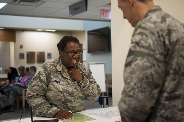 U.S. Air Force Capt. Brian Welch, 17th Medical Support Squadron pharmacist, assists Tech. Sgt. Vanessa Gosha, 17th Medical Support Squadron pharmacy technician, with her medical treatments at the Ross Clinic on Goodfellow Air Force Base, Texas, June 15, 2017. Welch became interested in pharmacy while in college. (U.S. Air Force photo by Senior Airman Scott Jackson/released)