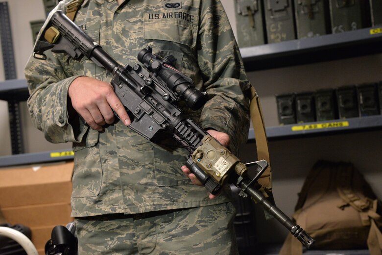 Senior Airman Tyler Merrill, 341st Security Forces Support Squadron armorer, demonstrates the proper holding of a weapon June 9, 2017, at Malmstrom Air Force Base, Mont. Fingers should be kept outside the trigger guard or along the side of the weapon until ready to shoot. (U.S. Air Force photo/Airman 1st Class Daniel Brosam)