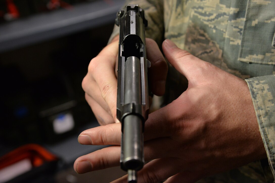 Senior Airman Tyler Merrill, 341st Security Forces Support Squadron armorer, shows an empty chamber June 9, 2017, at Malmstrom Air Force Base, Mont. Firearms will always be unloaded during transportation and placed in the trunk or the rear most compartment of a vehicle. (U.S. Air Force photo/Airman 1st Class Daniel Brosam)