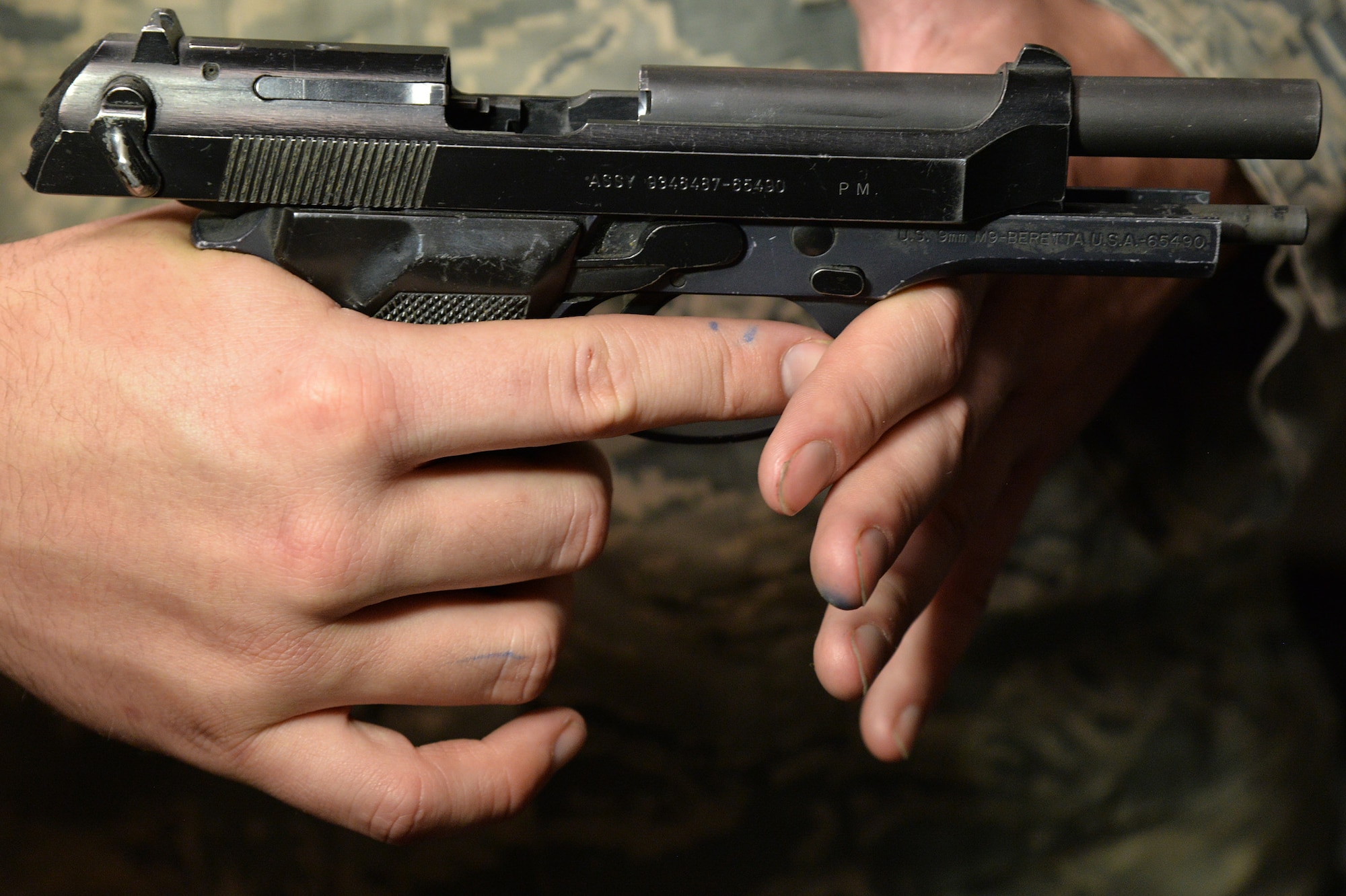Senior Airman Tyler Merrill, 341st Security Forces Support Squadron armorer, demonstrates pointing a weapon in a safe direction June 9, 2017, at Malmstrom Air Force Base, Mont. A safe direction means the weapon is pointed so that even if an accidental discharge did occur, it would not result in injury. (U.S. Air Force photo/Airman 1st Class Daniel Brosam)
