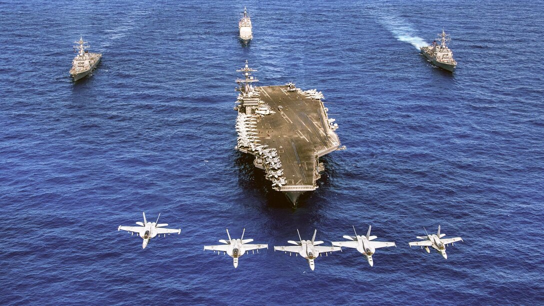 Navy F/A-18 Hornets and Super Hornets fly over the aircraft carrier USS Carl Vinson, front; the guided-missile destroyers USS Wayne E. Meyer, right, and USS Michael Murphy, left; and the guided-missile cruiser USS Lake Champlain in the western Pacific Ocean, June 12, 2017. Navy photo by Petty Officer 2nd Class Sean M. Castellano