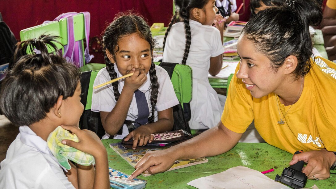 Navy Petty Officer 3rd Class Sarah Perez talks with students during a community engagement event at the Kalutara-Molkawa School near Kalutara, Sri Lanka, June 15, 2017. Sailors assigned to the USS Lake Erie were in Sri Lanka conducting humanitarian assistance operations following severe flooding and landslides. Navy photo by Petty Officer 2nd Class Joshua Fulton
