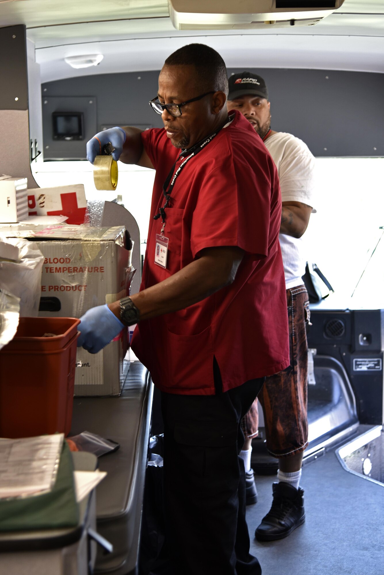 Zachary Harris, American Red Cross staff member, seals a box of blood units June 15, 2017 at Warfield Air National Guard Base, Middle River, Md. before passing it over to be delivered and processed at regional hospitals. Harris has been an employee for the American Red Cross for five years. (U.S. Air National Guard photo by Airman Sarah M. McClanahan)