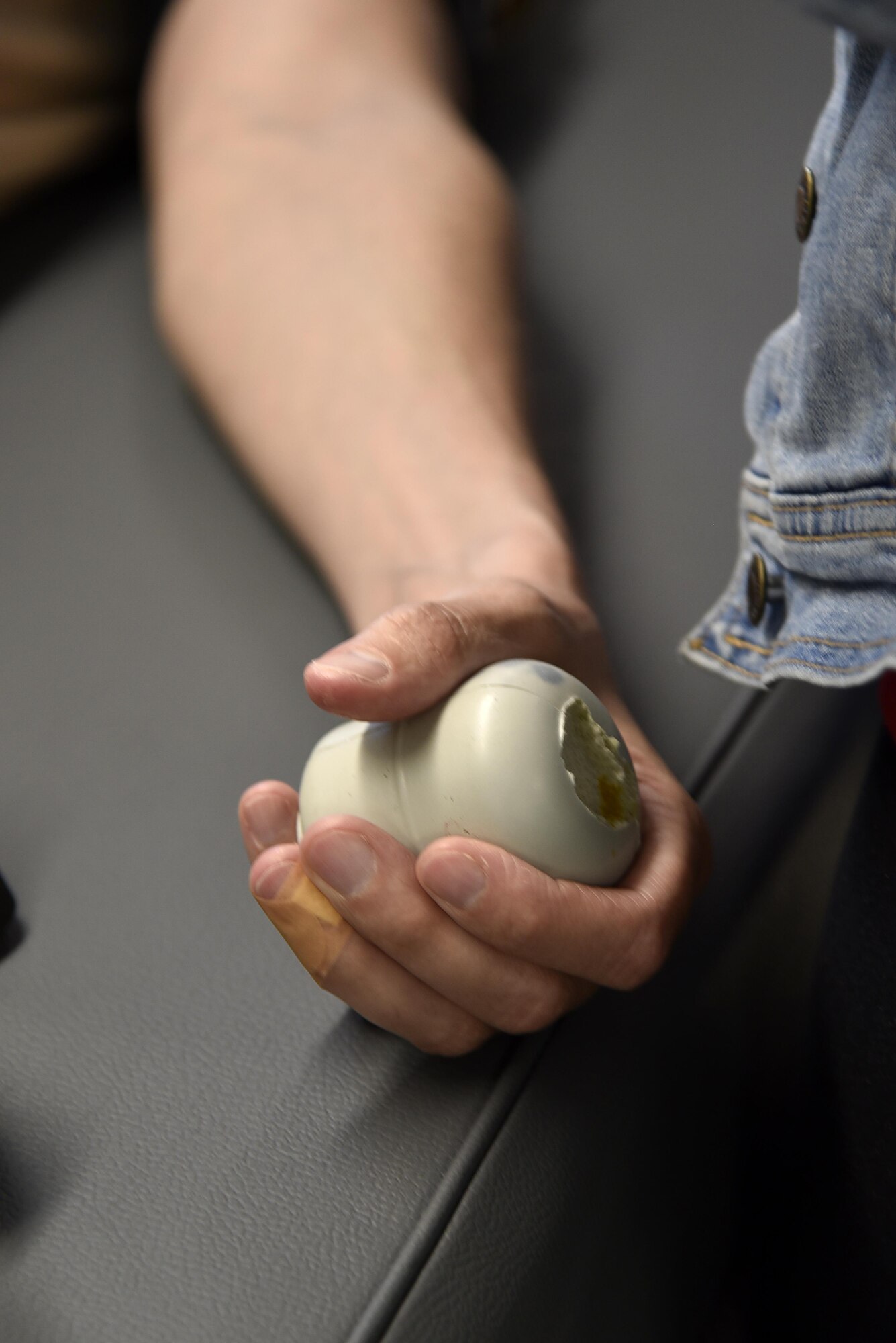 Air Force Maj. Tim Keegan, budget officer assigned to the 175th Comptroller Flight, squeezes a foam ball June 15, 2017 while donating blood at Warfield Air National Guard Base, Middle River, Md. The American Red Cross holds blood drives on base twice annually. (U.S. Air National Guard photo by Airman Sarah M. McClanahan)