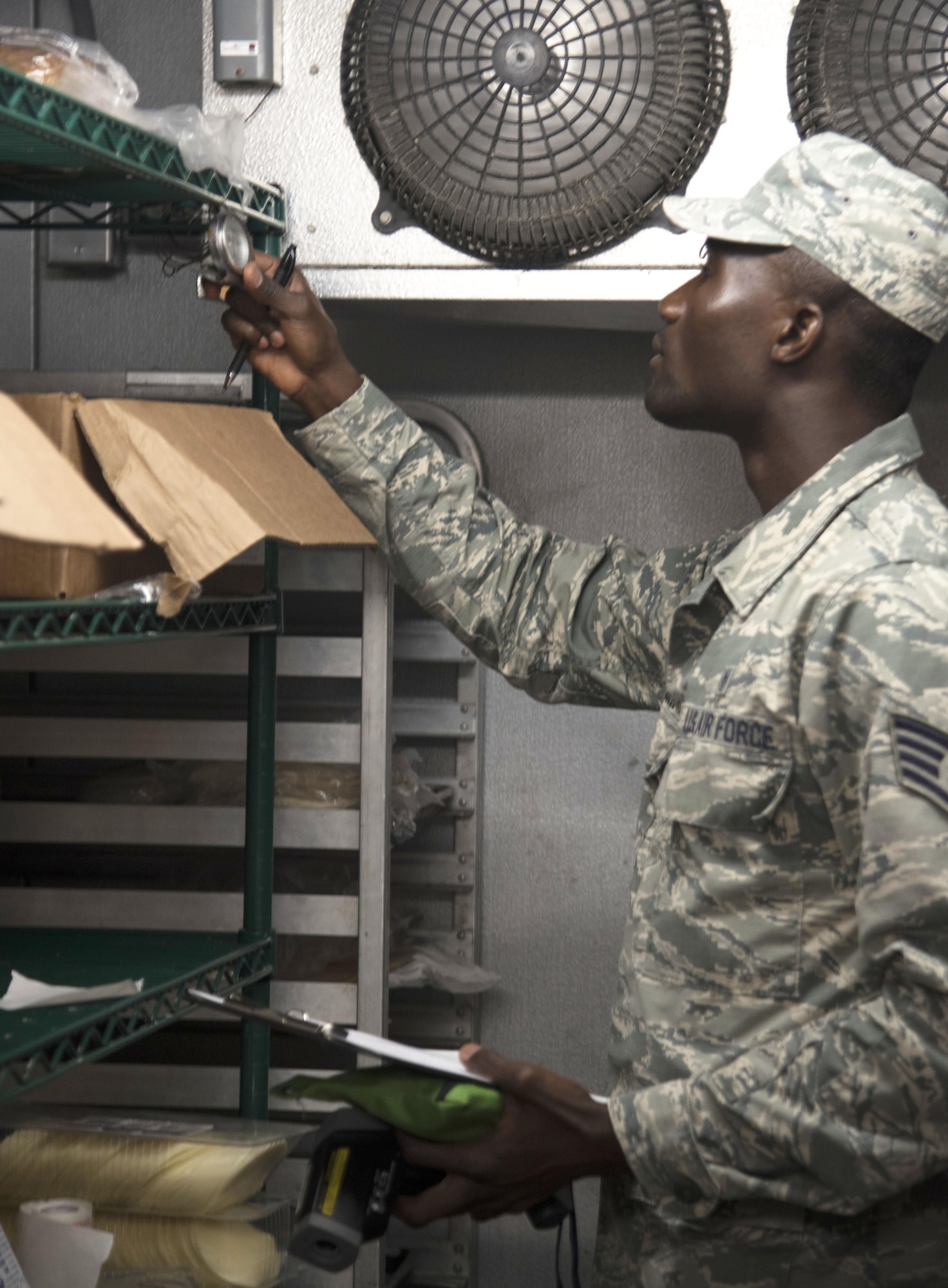 U.S. Air Force Staff Sgt. Cornelius Bransah, the NCO in charge of food safety and sanitation assigned to the 6th Aerospace Medical Squadron, checks a thermometer inside a walk-in refrigerator at MacDill Air Force Base, Fla., June 13, 2017. Bransah routinely inspects more than 50 facilities on MacDill, ensuring the food and the facilities are safe for the public. (U.S. Air Force photo by Airman 1st Class Adam R. Shanks)