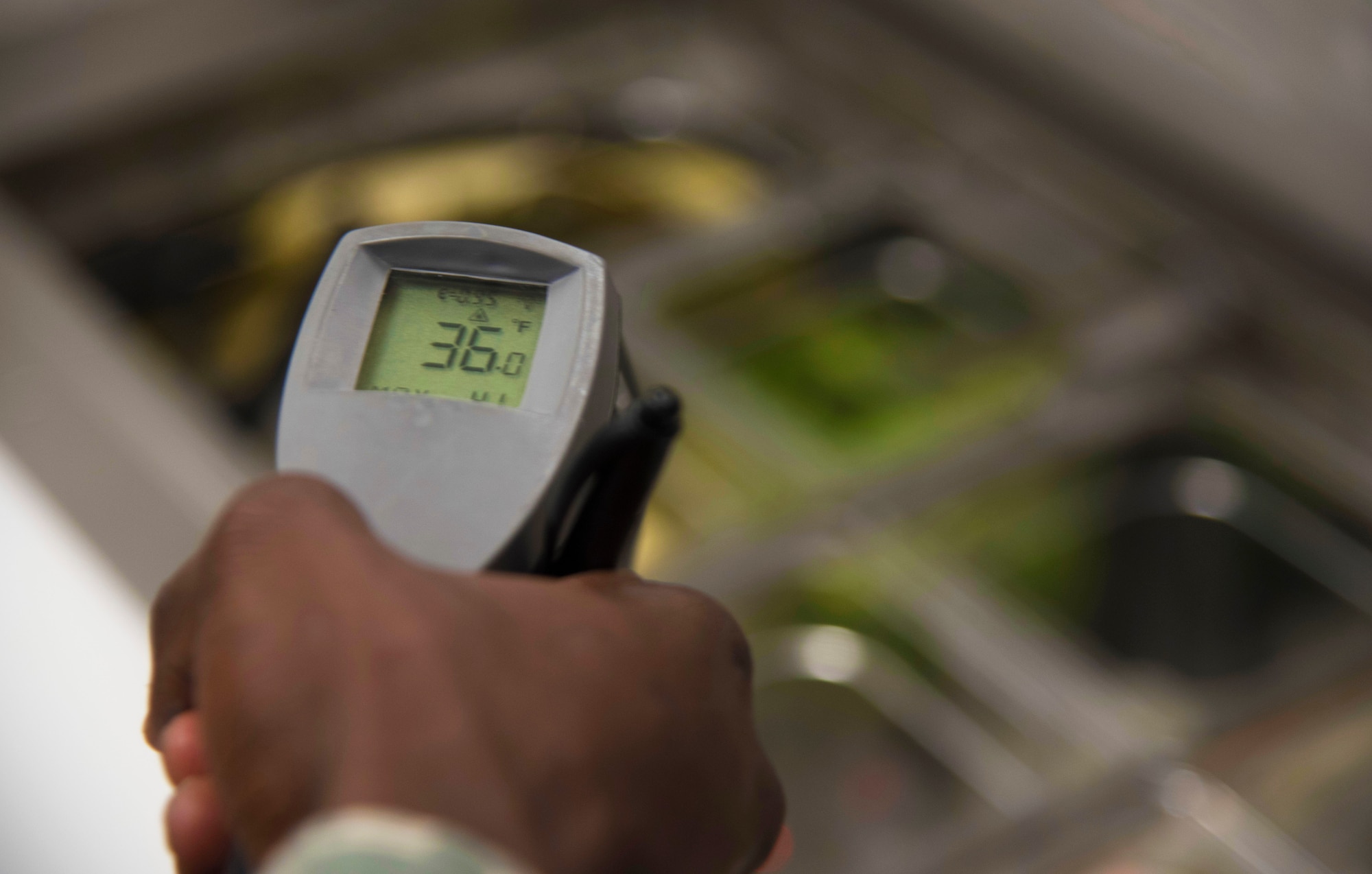 U.S. Air Force Staff Sgt. Cornelius Bransah, the NCO in charge of food safety and sanitation assigned to the 6th Aerospace Medical Squadron, uses a handheld infrared thermometer to check the temperatures of food items at MacDill Air Force Base, Fla., June 13, 2017. Bransah inspects in accordance to the Tri-Service Food Code to make sure food prepared on MacDill is at the correct temperature. (U.S. Air Force photo by Airman 1st Class Adam R. Shanks)