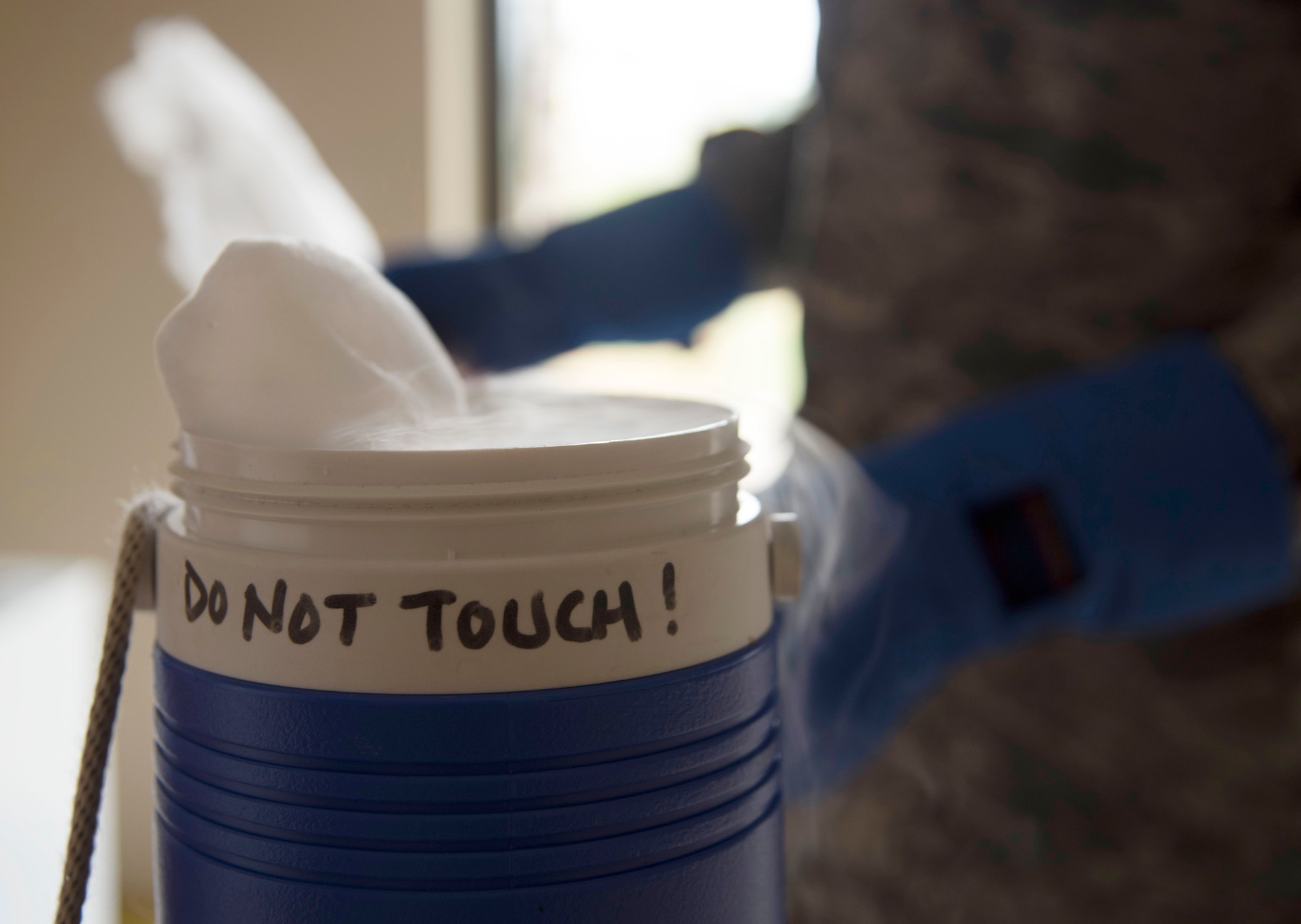 U.S. Air Force Staff Sgt. Cornelius Bransah, the NCO in charge of food safety and sanitation assigned to the 6th Aerospace Medical Squadron, fills a small cooler with dry ice to use as bait for a mosquito trap at MacDill Air Force Base, Fla., June 13, 2017. Dry ice is solid carbon dioxide which sublimates, producing carbon dioxide gas, which mimics a human exhaling, attracting mosquitoes toward the trap. (U.S. Air Force photo by Airman 1st Class Adam R. Shanks)