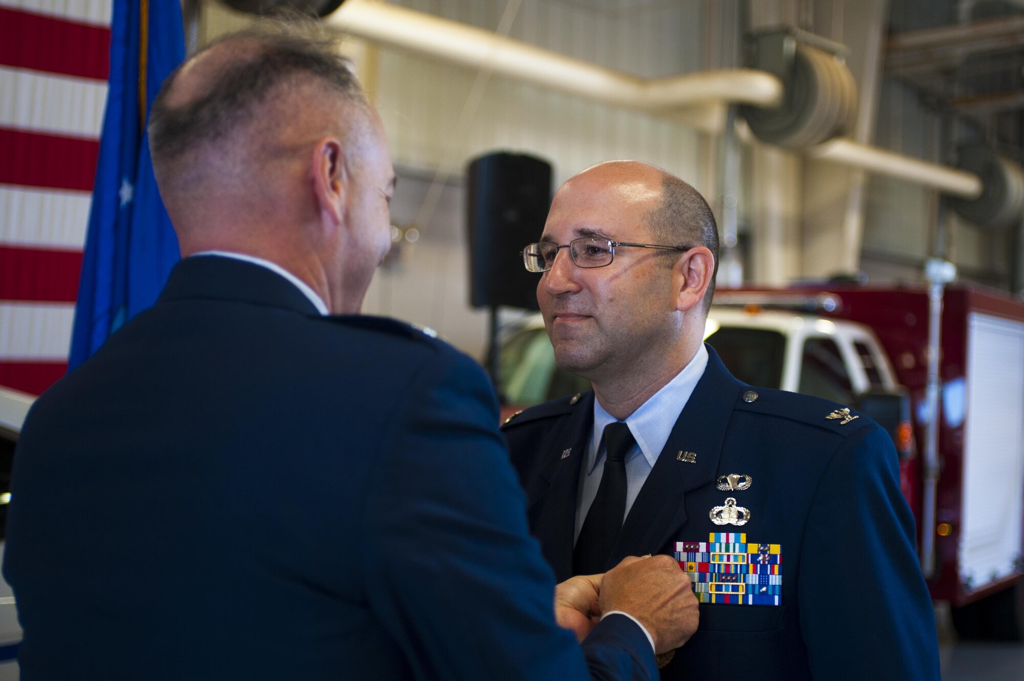 U.S. Air Force Col. Christopher Harris, 17th Mission Support Group Commander, receives the meritorious servicemedal from Col. Michael Downs, 17th Training Wing Commander, at the Logistics and Readiness High Bay on Goodfellow Air Force Base, Texas, June 16, 2017. Harris served as 17 MSG commander from 2014 to 2016. (U.S. Air Force photo by Senior Airman Scott Jackson/Released)