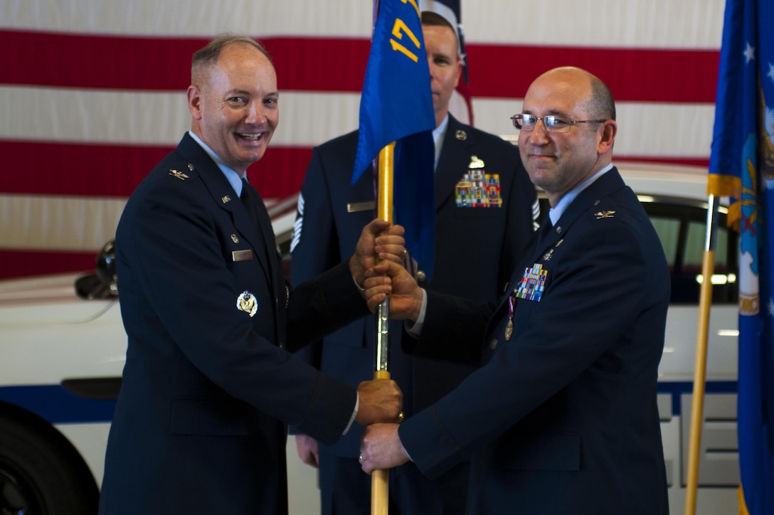U.S. Air Force Col. Christopher Harris, 17th Mission Support Group Commander, passes the unit guideon to Col. Michael Downs, 17th Training Wing Commander, during the 17th MSG Change of Command ceremony at the Logistics and Readiness High Bay on Goodfellow Air Force Base, Texas, June 16, 2017. The event honored Harris’s service to his unit and welcomed its new commander, Col. Jason Beck. (U.S. Air Force photo by Senior Airman Scott Jackson/Released)