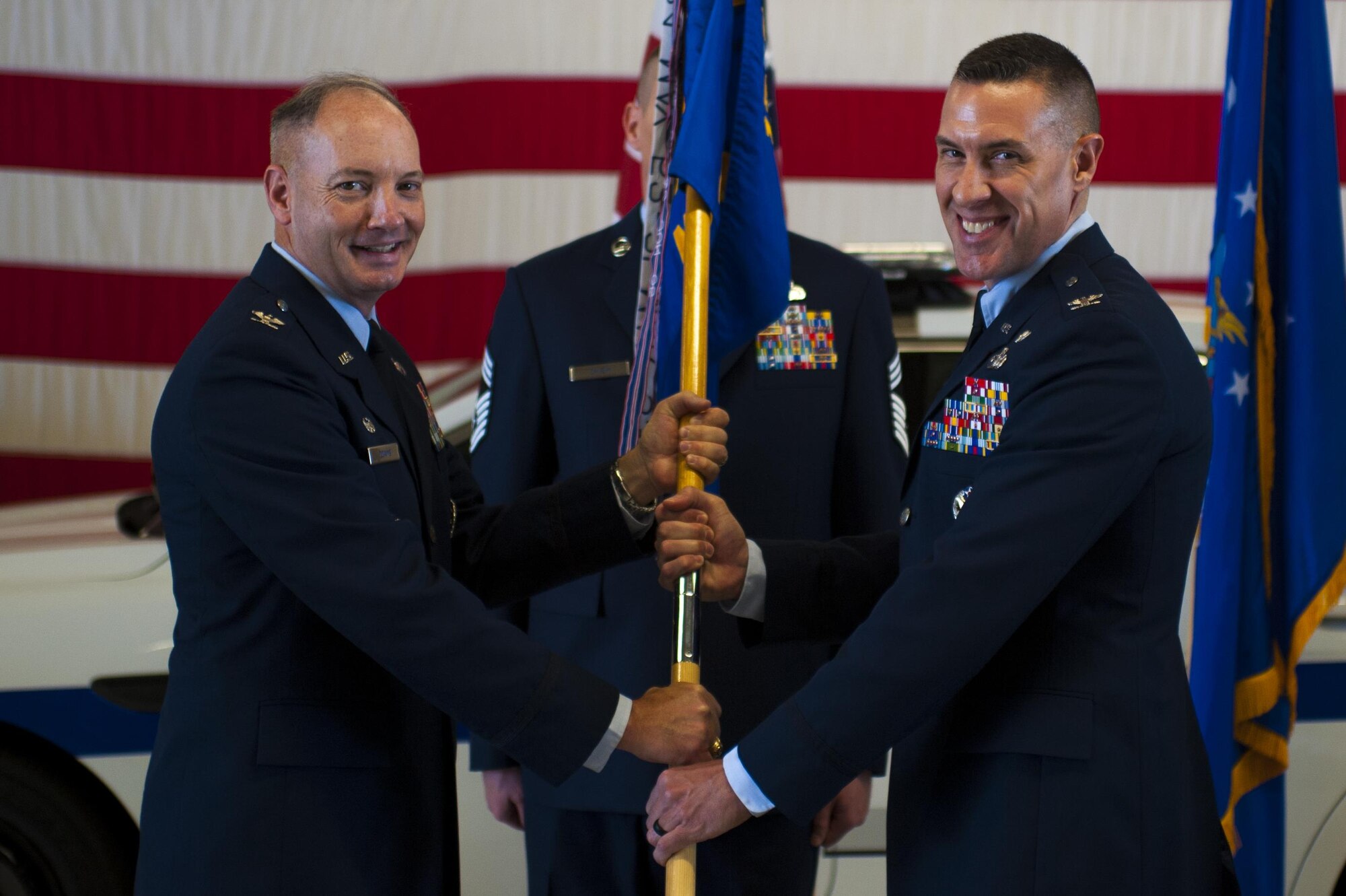 U.S. Air Force Col. Jason Beck, the new 17th Mission Support Group Commander, receives the guideon from Col. Michael Downs, 17th Training Wing Commander, during the 17th MSG Change of Command ceremony at the Logistics and Readiness High Bay on Goodfellow Air Force Base, Texas, June 16, 2017. Beck previously served the Branch Chief of Antiterrorism Plans and Programs at Headquarters United States Pacific Command. (U.S. Air Force photo by Senior Airman Scott Jackson/Released)