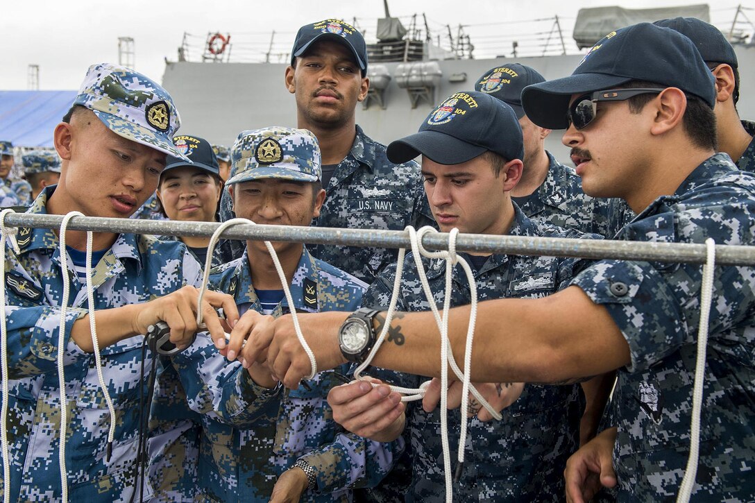 U.S. and Chinese sailors practice tying knots before a seamanship competition in Zhanjiang, China, June 14, 2017. The U.S. sailors are assigned to the USS Sterett, which is conducting a scheduled port visit to the city. Navy photo by Petty Officer 1st Class Byron C. Linder