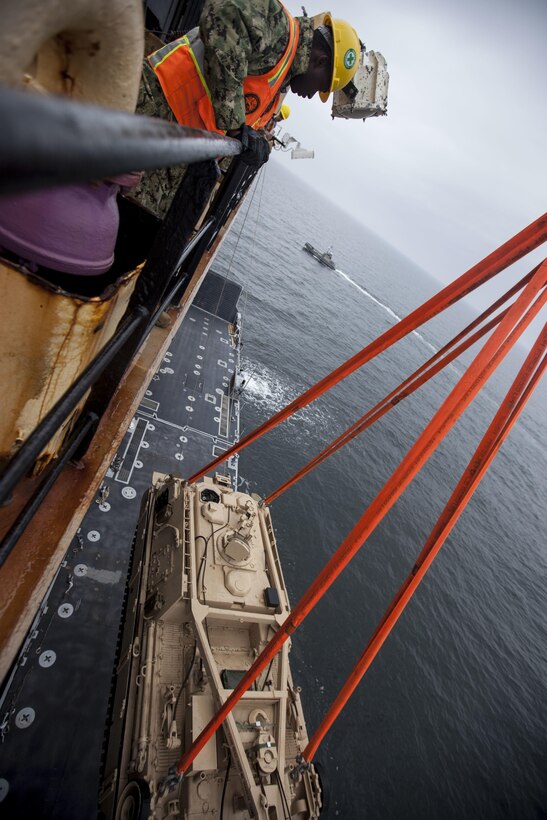 VENTSPILS, Latvia-U.S. Sailors with Navy Cargo Handling Battalion One, conduct the off-loading of tanks during exercise Saber Strike 17 in Ventspils, Latvia, May 23, 2017 Exercise Saber Strike 17 is an annual combined-joint exercise conducted at various locations throughout the Baltic region and Poland. The combined training prepares allies and partners to respond more to regional crises and meet their own security needs by improving the security of borders and countering threats. (U.S. Marine Corps photo by Lance Cpl. Ricardo Davila/Released)