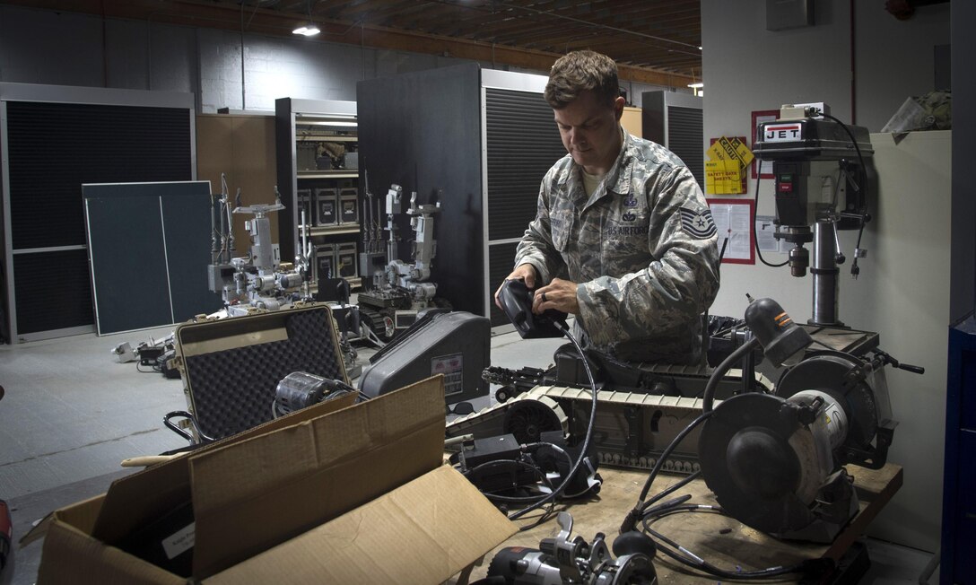 Tech. Sgt. Lucas Mefford, 11th Civil Engineer explosive ordinance disposal craftsman, inspects a functioning dismounted robot system, at Joint Base Andrews, Md., June 6, 2017. Mefford attended an inpatient program at the National Intrepid Center of Excellence program, in Bethesda, Md., for depression, insomnia, and other symptoms. He continues his medical treatment at JBA and hopes to influence his Airmen to be advocates for their health. (U.S. Air Force photo by Senior Airman Mariah Haddenham)