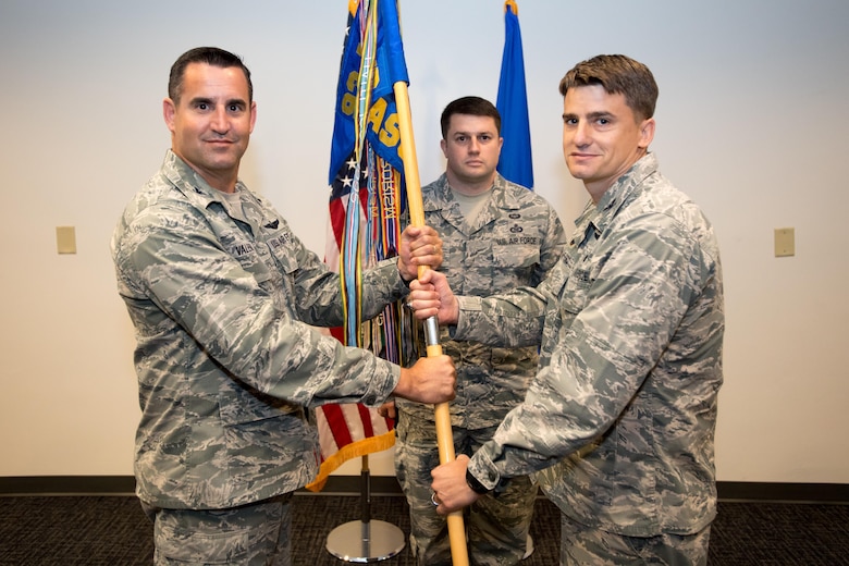 Col. Dane Crawford (right) accepts the 18th Air Support Operations Group guidon from Col. Jeffery Valenzia, 93rd Air Support Operations Wing commander, during a change-of-command ceremony here June 7. Crawford took command of the group from Col. Christopher Jensen, who left Pope for an assignment at Joint Base Pearl Harbor-Hickam, Hawaii. 