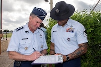 Air Force Chief of Staff Gen. David Goldfein, signs oath of enlistment paperwork for Senior Master Sgt. Steven Beasley, 737th Training Group superintendent of standardization and evaluation, prior to the start of basic military training graduation June 16, 2017, at Joint Base San Antonio-Lackland. Goldfein toured various JBSA-Lackland facilities and met many 37th Training Wing Airmen during his two-day visit. Beasley joined BMT Airmen in reciting the oath as Goldfein administered during the graduation. (U.S. Air Force photo by Johnny Saldivar)