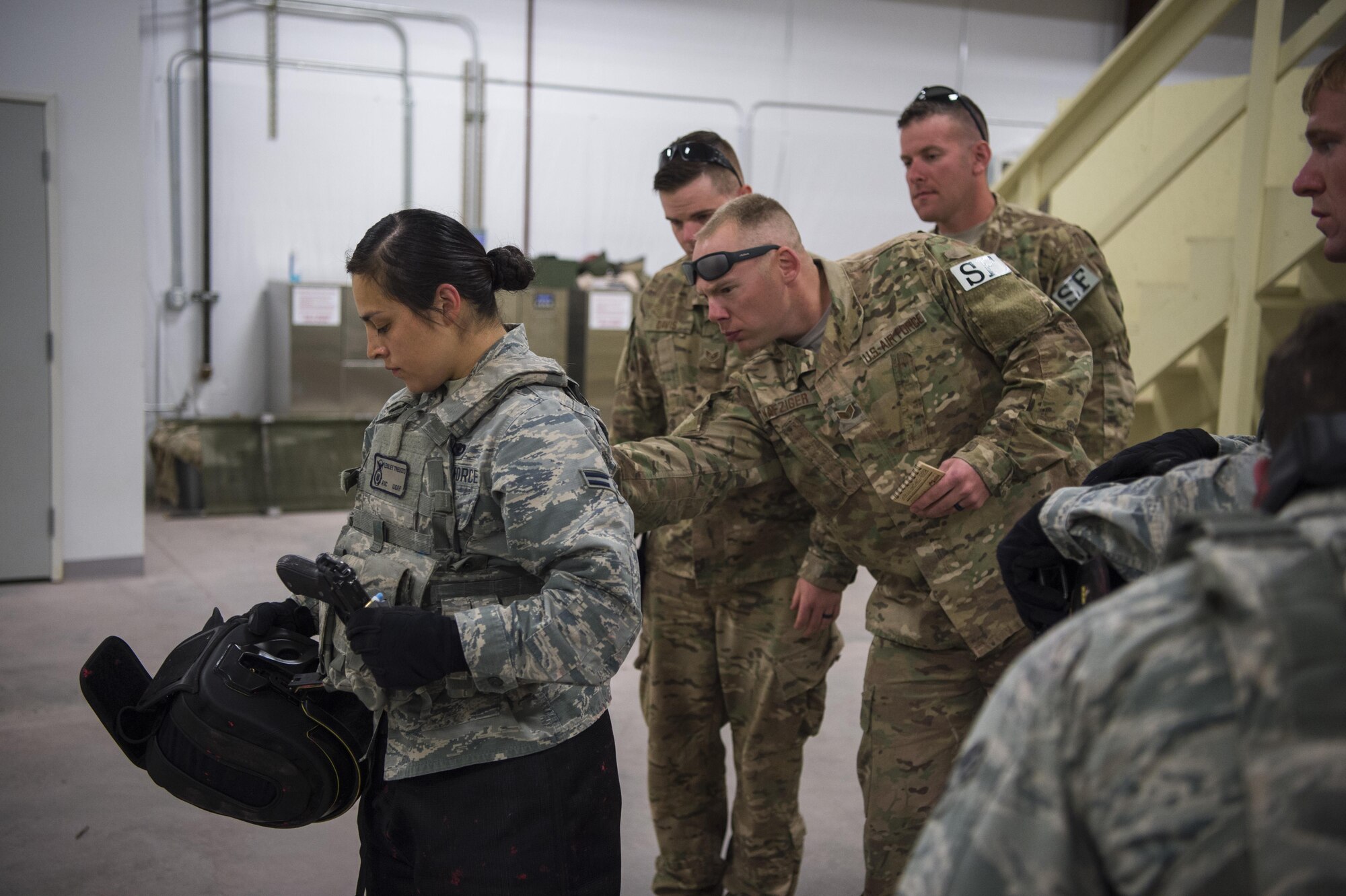 Airman 1st Class Lesley Trevizo, 28th Security Forces Squadron response force member from Ellsworth Air Force Base, S.D., is inspected for paint ball markings by 620th Ground Combat Training Squadron instructors during the 2017 Global Strike Challenge at Camp Guernsey, Wyo., May 18, 2017. The security forces portion is just one of the many competitions, spread out over the next several weeks, which make up the Global Strike Challenge. Missile wings vie for supremacy in security, missile maintenance and operations. (U.S. Air Force photo by Staff Sgt. Christopher Ruano)