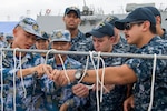 Sailors assigned to Arleigh Burke-class guided-missile destroyer USS Sterett (DDG 104) practice tying knots together before a seamanship competition with People’s Liberation Army (Navy) (PLAN) sailors during the ship’s scheduled port visit to Zhanjiang, China. Sterett is part of the Sterett-Dewey Surface Action Group and is the third deploying group operating under the command and control construct called 3rd Fleet Forward, June 14, 2017. U.S. 3rd Fleet operating forward offers additional options to the Pacific Fleet commander by leveraging the capabilities of 3rd and 7th Fleets. 