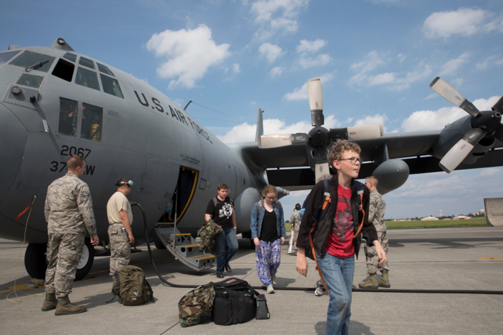 Family members representing installations and commands throughout the Korean Peninsula exist a U.S. Air Force C-130 Hercules at Yokota Air Base, Japan, June 6, 2017 for noncombatant evacuation exercise Focused Passage 2017. The exercise takes place at US military installations throughout the Korean Peninsula and is designed to ensure service members are prepared to evacuate designated noncombatants.