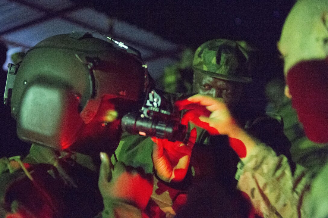 A Zambian Air Force Airman trains on the night vision goggles with members of the 818th Mobility Support Advisory Squadron in Lusaka, Zambia, May 31, 2017. The MSAS illustrates the U.S. commitment with regional partners in ways that expand cooperation between counterparts, bolster partner nation capacity, enhance trust and transparency, and create cooperative solutions. (U.S. Air Force photo by Tech. Sgt. Gustavo Gonzalez/RELEASED)