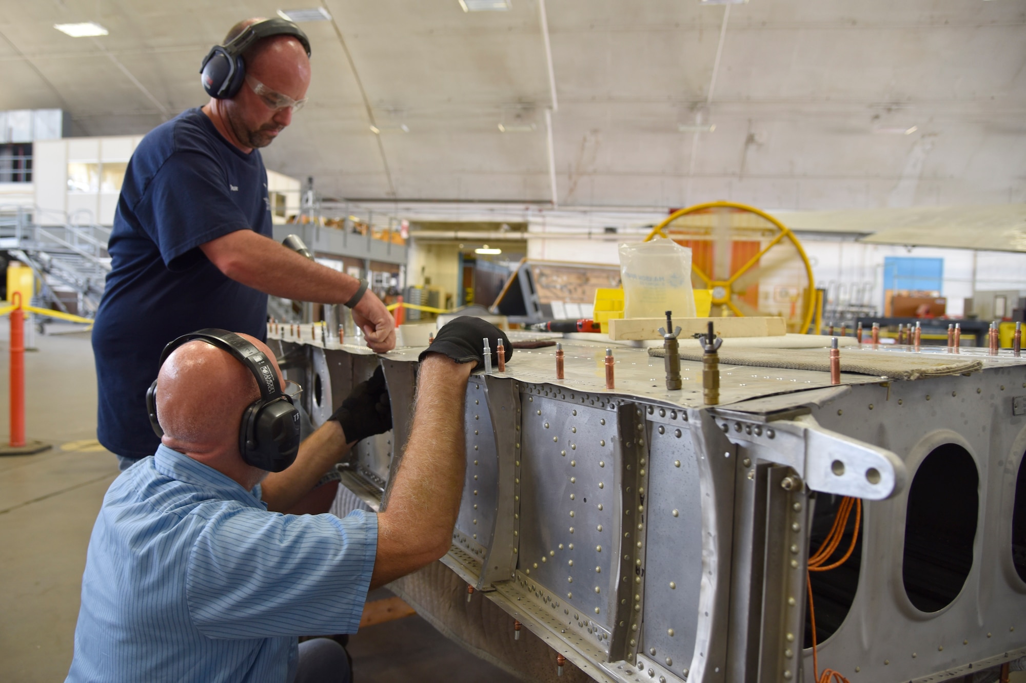 DAYTON, Ohio (06/2017) -- (From left to right) Restoration Specialists Duane Jones and Roger Brigner work on the B-17F "Memphis Belle"™ in the restoration hangar at the National Museum of the U.S. Air Force. The exhibit opening for this aircraft is planned for May 17, 2018.(U.S. Air Force photo by Ken LaRock)