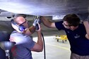 DAYTON, Ohio (06/2017) -- (From left to right) Restoration Specialists Chase Meredith and Jason Davis work on the B-17F &quot;Memphis Belle&quot;™ in the restoration hangar at the National Museum of the U.S. Air Force. The exhibit opening for this aircraft is planned for May 17, 2018.(U.S. Air Force photo by Ken LaRock)
