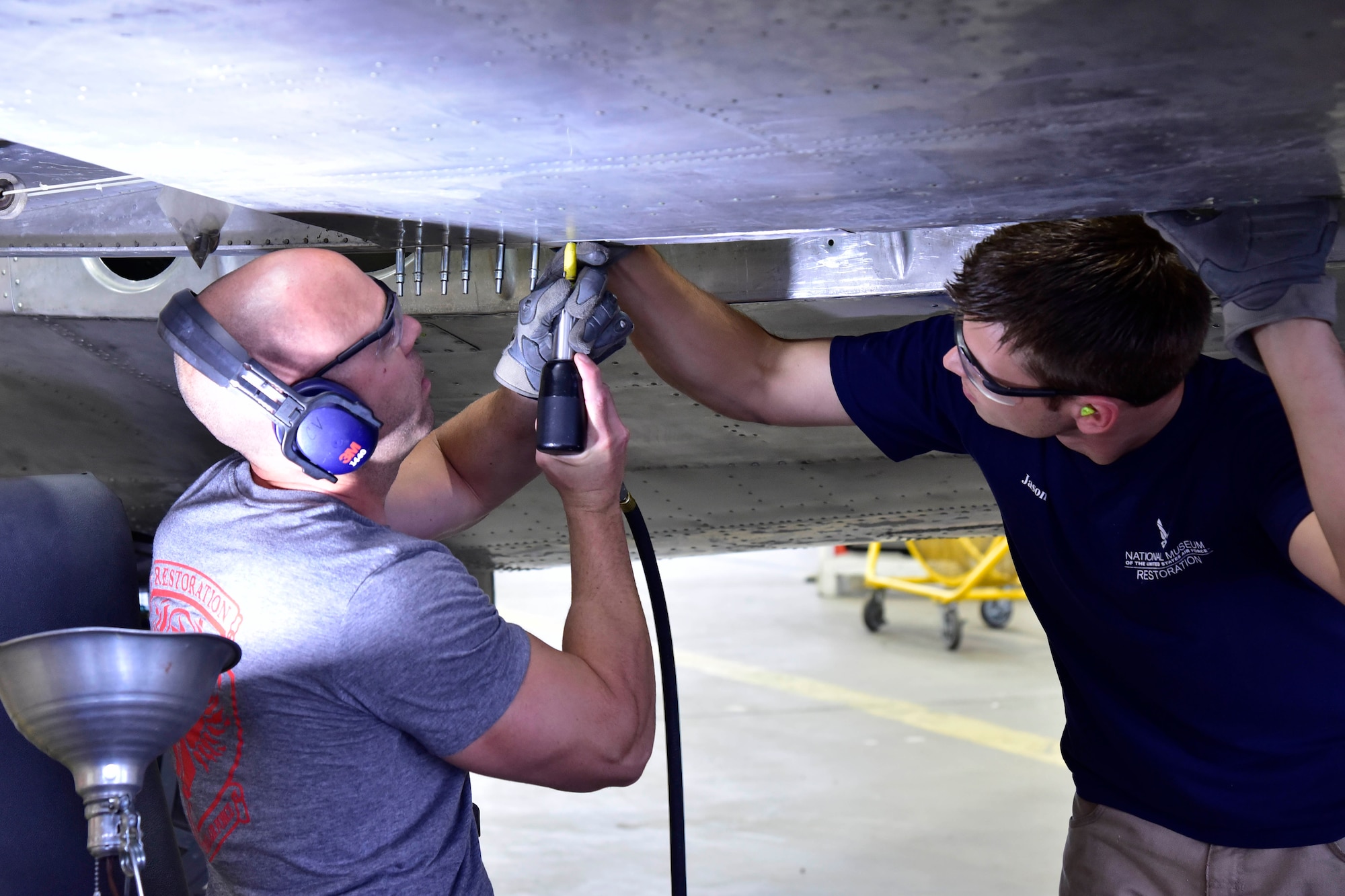 DAYTON, Ohio (06/2017) -- (From left to right) Restoration Specialists Chase Meredith and Jason Davis work on the B-17F "Memphis Belle"™ in the restoration hangar at the National Museum of the U.S. Air Force. The exhibit opening for this aircraft is planned for May 17, 2018.(U.S. Air Force photo by Ken LaRock)
