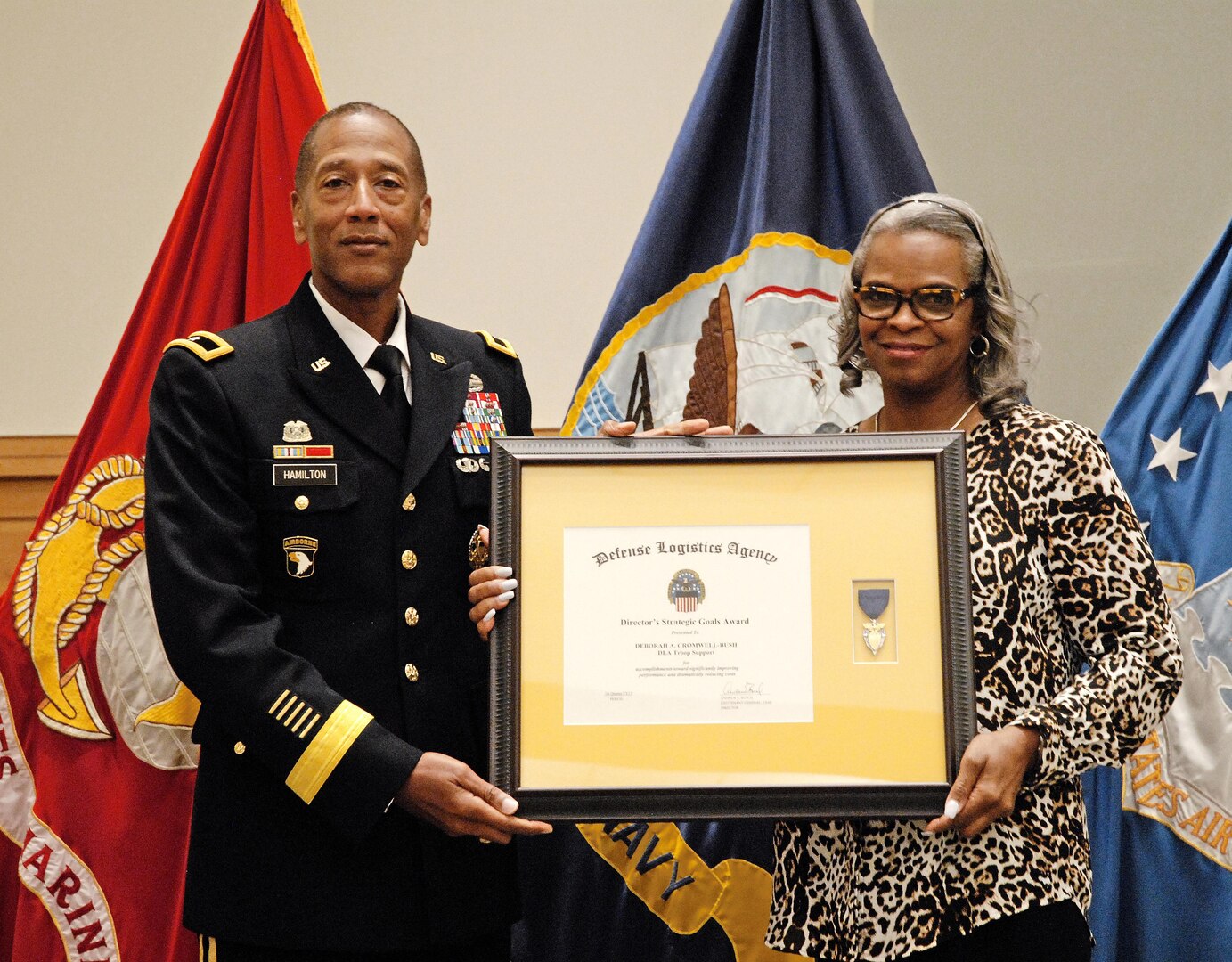 DLA Troop Support Commander Army Brig. Gen. Charles Hamilton recognizes Deborah Cromwell-Bush as the DLA Director’s Strategic Process Excellence Goal winner for the first quarter of fiscal 2017 during a ceremony in DLA Troop Support’s auditorium June 6. The award cited her numerous accomplishments, including her design of four centralized, user friendly databases used to track, categorize and manage contracting workloads within the Industrial Hardware supply chain.