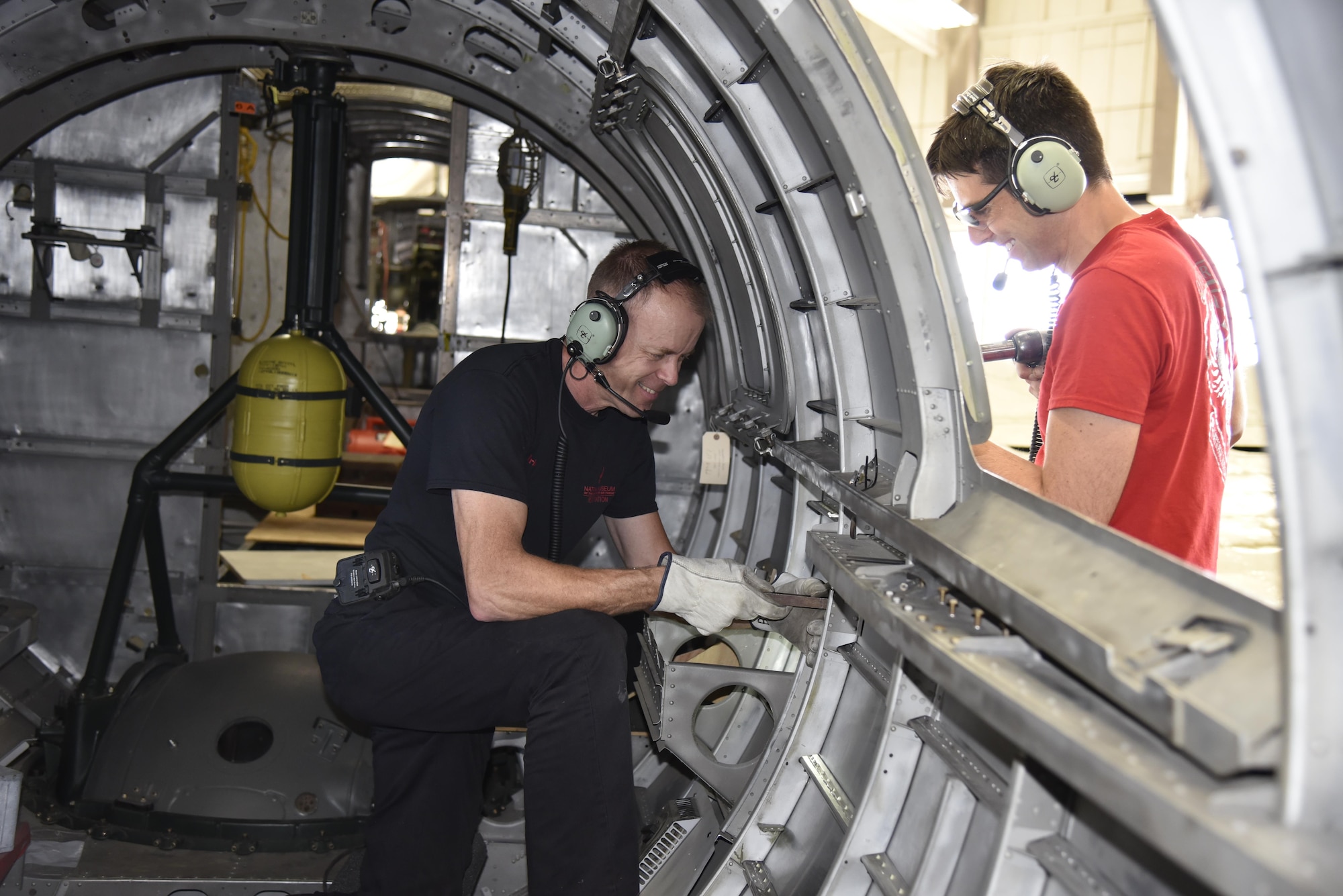 DAYTON, Ohio (06/2017) -- (From left to right) Restoration Specialists Brian Lindamood and Casey Simmons work on the fuselage of the B-17F "Memphis Belle"™ in the restoration hangar at the National Museum of the U.S. Air Force. The exhibit opening for this aircraft is planned for May 17, 2018.(U.S. Air Force photo by Ken LaRock)