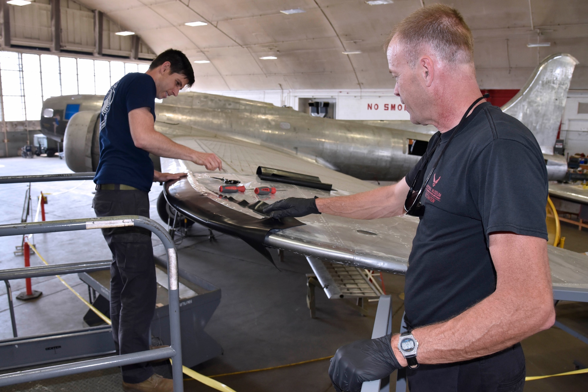 DAYTON, Ohio (06/2017) -- (From left to right) Restoration Specialists Casey Simmons and Brian Lindamood work on the B-17F "Memphis Belle"™ in the restoration hangar at the National Museum of the U.S. Air Force. The exhibit opening for this aircraft is planned for May 17, 2018.(U.S. Air Force photo by Ken LaRock)