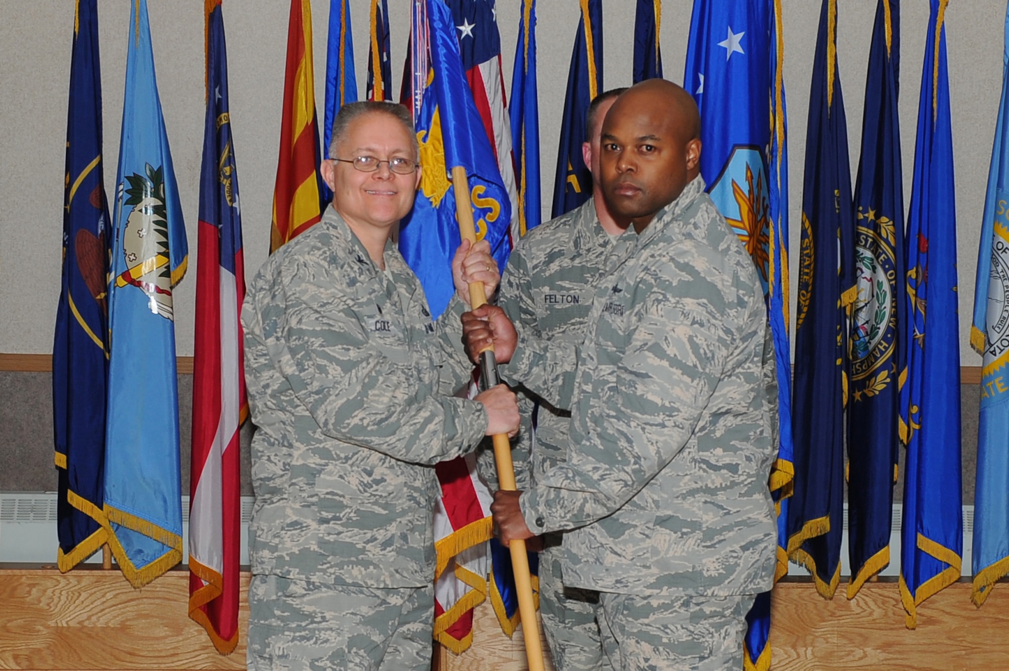 U.S. Air Force Col. Richard Cole, left, the 354th Mission Support Group commander, passes the 354th Communications Squadron (354th CS) guidon to Maj. Charles Dobson, the 354th CS commander, June 15, 2017, at Eielson Air Force Base, Alaska. Dobson assumed command from Maj. Aaron Lake who will move on to Maxwell Air Force Base, Alabama. (U.S. Air Force photo by Airman Eric M. Fisher)