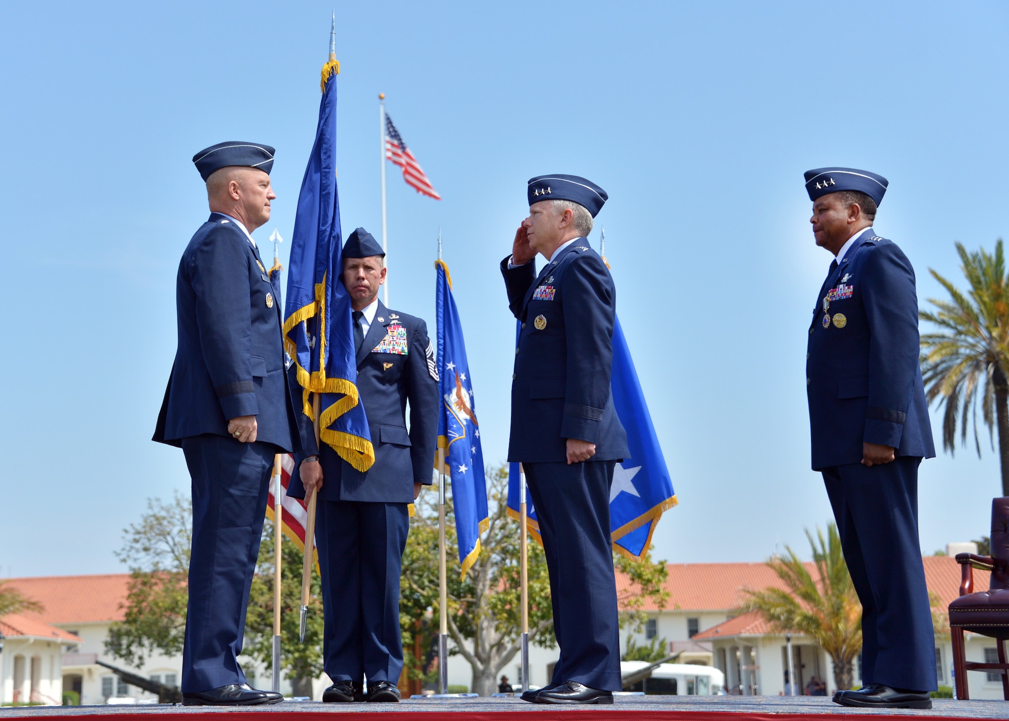 Lt. Gen. John Thompson, incoming SMC commander, salutes Gen. John Raymond, Air Force Space Command commander, as Lt. Gen. Samuel Greaves, outgoing SMC commander looks on during the SMC change of command ceremony, May 22. (US Air Force photo/Van Ha)