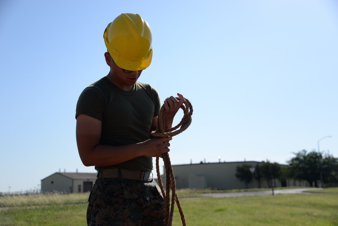 Lance Cpl. Jeffrey Regullano, 364th Training Squadron cables and antenna systems apprentice course student, daisy chains rope before storage. Daisy chaining saves space, keeps everything organized and makes it readily available for use. (U.S. Air Force photo by Senior Airman Robert L. McIlrath)