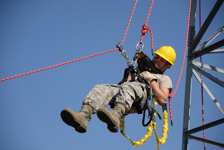 Airman 1st Class Ryan Ferguson, 364th Training Squadron cables and antenna systems apprentice course student, trains on how to do a ground based belay assist tower rescue. Several situations like equipment failure or injury could leave the climber unable to descend the tower on their own. This method is the safest method of retrieving someone from the tower because it only puts the person descending at risk, no one else. (U.S. Air Force photo by Senior Airman Robert L. McIlrath)