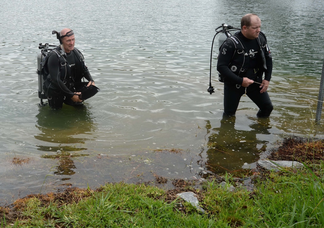 City of Albany’s Fire and Rescue Department’s Dive Team members emerge from the murky waters at Marine Corps Logistics Base Albany’s Covella Pond during a “Lost-Child” full-scale exercise, June 13. In the scenario, emergency responders had received a report that a young boy had been seen entering the pond earlier. The training was implemented in collaboration with the city’s mutual partners to evaluate reaction and response time in the event that this had been an actual occurrence.