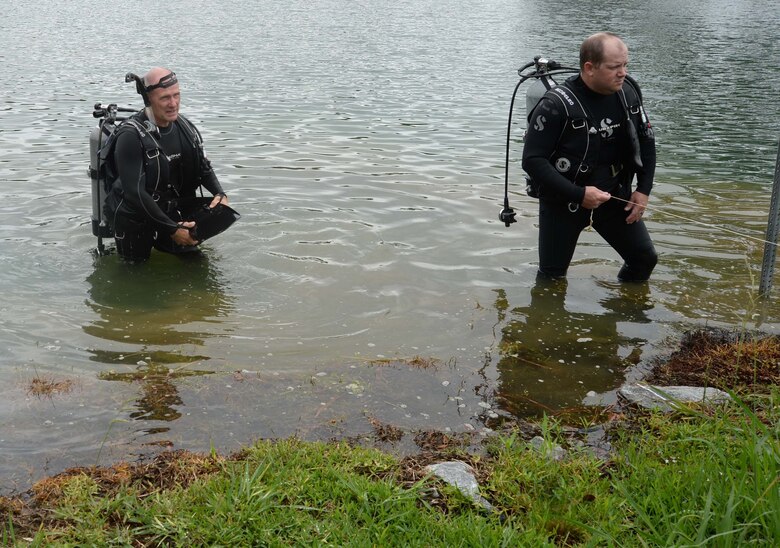 City of Albany’s Fire and Rescue Department’s Dive Team members emerge from the murky waters at Marine Corps Logistics Base Albany’s Covella Pond during a “Lost-Child” full-scale exercise, June 13. In the scenario, emergency responders had received a report that a young boy had been seen entering the pond earlier. The training was implemented in collaboration with the city’s mutual partners to evaluate reaction and response time in the event that this had been an actual occurrence.