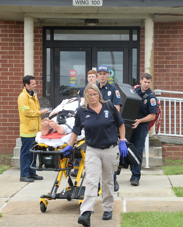 Marine Corps Logistics Base Albany's first responders transport a cardiac arrest victim from an office in Building 3500, Wing 100, during a “Lost Child” full-scale exercise on the installation, June 13. The activity was part of a secondary scenario, when an emergency call went out requesting medical assistance for a male who had collapsed. There were roughly 50-60 personnel from the base as well as the city’s mutual partners, who participated in both events in the day-long activities.
