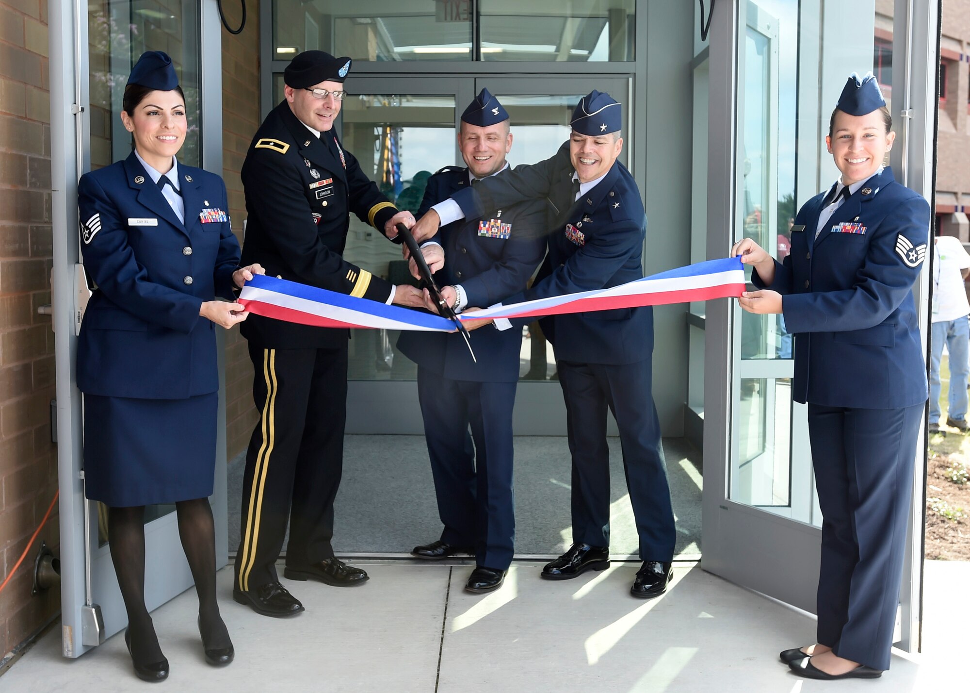 From left to right, Brig. Gen. Jeffrey Johnson, Col. Michael Richards and Brig. Gen. John DeGoes cuts the ribbon to officially open the undersea and hyperbaric medicine clinic, June 16, at the San Antonio Military Medical Center on Joint Base San Antonio-Fort Sam Houston, Texas. The hyperbaric medicine provides treatment for wound care, decompression sickness, arterial gas embolisms, carbon monoxide poisoning and provides the only active duty hyperbaric fellowship program