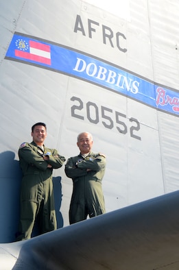 1st Lt. Will Jones, 700th Airlift Squadron pilot, left, and Lt. Col. John Jones, 94th Operations Group deputy commander, pose for a photo on the Dobbins Air Reserve Base flightline May 25, 2017. The father and son aviators began working together at Dobbins earlier this year. (U.S. Air Force photo/Don Peek)