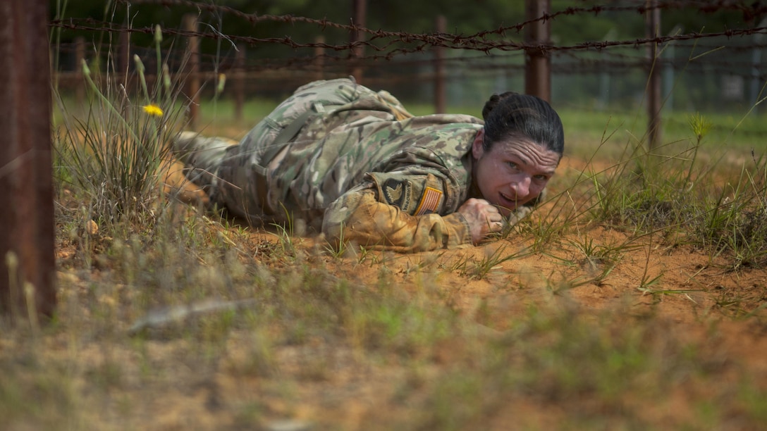 Army Sgt. Erin Hodge low-crawls under barbed wire during the 2017 Army Reserve Best Warrior Competition at Fort Bragg, N.C., June 13, 2017. Hodge is a preventive medicine specialist assigned to the 7th Mission Support Command. Army photo by Spc. Milcah Villaronga