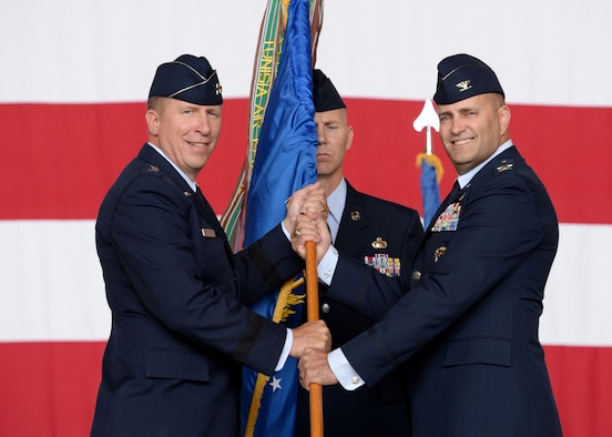 U.S. Air Force Major General Patrick J. Doherty, 19th Air Force commander, passes the guidon to U.S. Air Force Col. Eric Carney, June 16, 2017, at Altus Air Force Base, Oklahoma. U.S. Air Force Col. Todd Hohn relinquished command of the wing to U.S. Air Force Col. Eric Carney, he will lead the base in the mission of forging combat mobility forces and deploying Airmen warriors. (U.S. Air Force Photo by Airman 1st Class Jackson N. Haddon/Released).