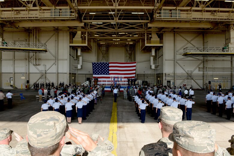 Members of the 97th Air Mobility Wing salute for the arrival of the official party and posting of the Colors, June 16, 2017, at Altus Air Force Base, Oklahoma. U.S. Air Force Col. Todd Hohn relinquished command of the wing to U.S. Air Force Col. Eric Carney, he will lead the base in the mission of forging combat mobility forces and deploying Airmen warriors. (U.S. Air Force Photo by Airman 1st Class Jackson N. Haddon/Released).