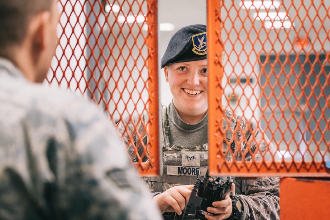 Senior Airman Adrienne Moore, 11th Security Forces Squadron patrolman, picks up equipment from the armory at Joint Base Andrews, Md., June 12, 2017. In addition to storing M4 carbines, M9 pistols, M249 light machine guns, and stored weapons for transient personnel, the armory also stores radios, pepper spray, tactical expandable batons and other items. (U.S. Air Force photo by Senior Airman Delano Scott)